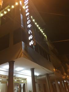 a sign on the side of a building at night at Hotel Premier Inn in Manta +12 photos