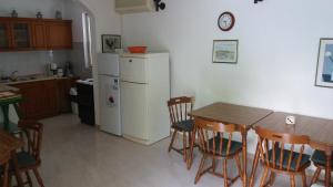 a kitchen with a table and a white refrigerator at Double Room Rab 12616b in Rab