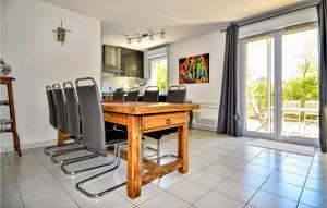 a dining room with a wooden table and chairs at Lovely Apartment In Orange With Kitchen in Orange