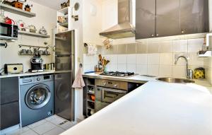 a kitchen with a sink and a washing machine at Lovely Apartment In Orange With Kitchen in Orange