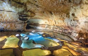 a cave with a river inside of it at Lovely Apartment In Orange With Kitchen in Orange +15 photos