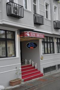 a hotel with a red staircase in front of a building at Efe Hotel EDİRNE in Edirne