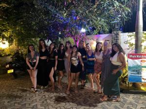 a group of women posing for a picture at night at Awon Mirissa in Mirissa