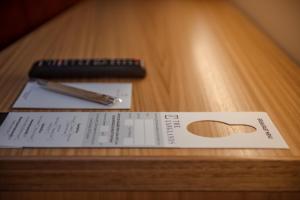 a piece of paper and a pen on a table at The Langlands Hotel in Invercargill