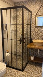 a bathroom with a shower with a toilet and a sink at Liman Hotel Gümüslük - Adult Only in Bodrum City