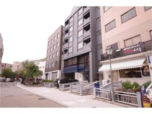a building with a car parked in front of a street at HOTEL APT SESELA - Vacation STAY 12883 in Kanazawa