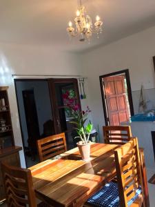 a dining room with a wooden table and chairs at Orchid Pool -Villa 3 bedrooms in Ko Lanta