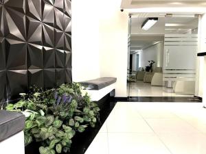 a lobby with a large potted plant on the floor at Apartment in the touristic heart of Mexico City in Mexico City
