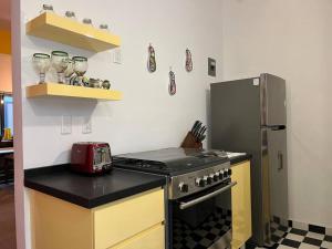 a kitchen with a stove and a refrigerator at Apartment in the touristic heart of Mexico City in Mexico City