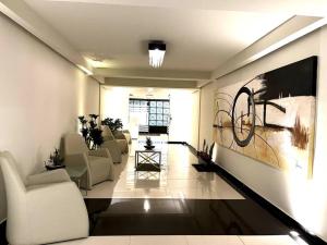 a living room with couches and a painting on the wall at Apartment in the touristic heart of Mexico City in Mexico City