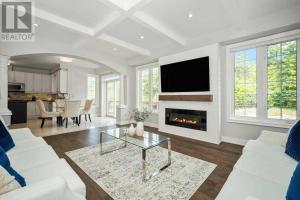 a living room with a white couch and a fireplace at Rooms in Luxury Vaughan Home in Vaughan