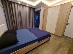ein Schlafzimmer mit einem blauen Bett und einem Schrank in der Unterkunft Özel havuzlu lüks villa in Kusadası + 11 Fotos