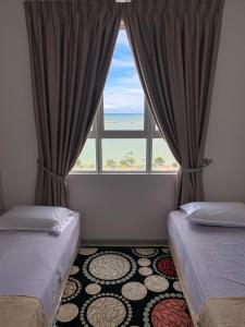 En eller flere senge i et værelse på The Caśa Homestay