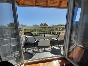 a balcony with chairs and a table with a view at La Hacienda DD in Trebinje