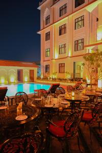 a restaurant with tables and chairs in front of a building at Ranbanka Heritage Resort in Bhilwara