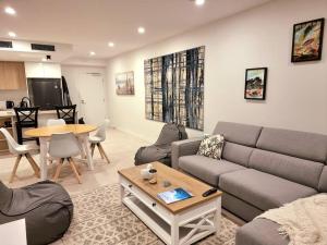 a living room with a couch and a table at Maroochy City Lights@Thecosmopolitan Unit 20802 in Maroochydore