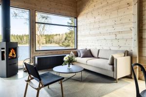 a living room with a couch and a fireplace at Tykkimäki Resort in Kouvola