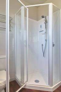 a shower with a glass door in a bathroom at Stunning Bob Lee Place in Wanaka