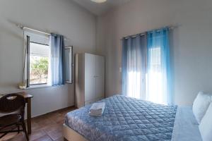 a bedroom with a bed and a window at Malia sea view in Pírgos