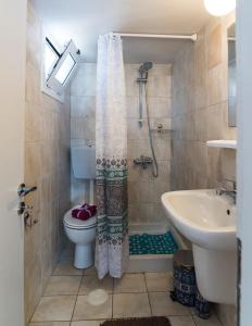 a bathroom with a shower and a toilet and a sink at Malia sea view in Pírgos