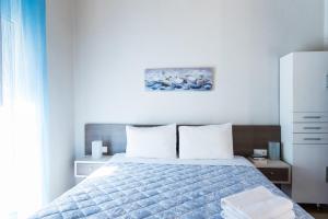 a bedroom with a bed with a blue comforter at Malia sea view in Pírgos