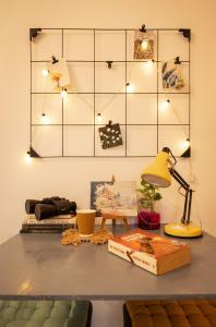 a table with a lamp and books on it at CollarCamp 1BHK Apartment in Navi Mumbai