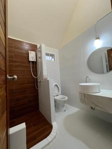 a bathroom with a shower and a toilet and a sink at Promma Farm Resort in Ban Tat Ton (1)
