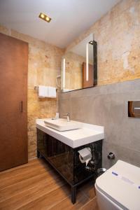 a bathroom with a sink and a toilet at Bayazhan Hotel ve Restaurant in Gaziantep