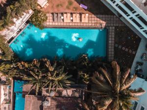 an overhead view of a swimming pool with palm trees at The Park Baga River Goa in Baga