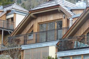 a wooden house with a deck on the side of it at Appartement Luisa in Bad Kleinkirchheim