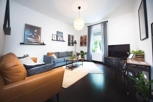 a living room with a couch and a tv at Zagreb Central Park Apartment with free parking in Zagreb