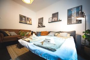 a bed in a living room with a couch at Zagreb Central Park Apartment with free parking in Zagreb