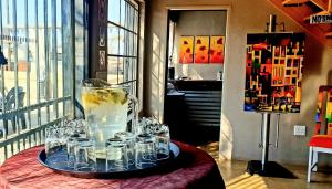 a tray of glasses and a pitcher of water on a table at The Darling Farmstyle B&B in Krugersdorp