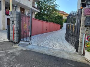 a gate to a building with a red fence at Apartments Bogdanovic in Kotor