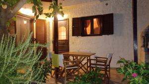 a patio with a table and chairs and a building at Villa Kalliopi 