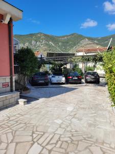 a parking lot with cars parked in front of a building at Apartments Bogdanovic in Kotor