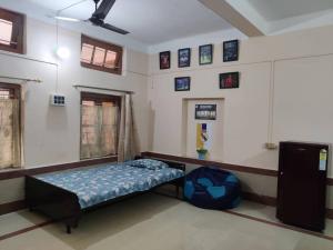 a bedroom with a bed in the corner of a room at Madrid Homes in Guwahati