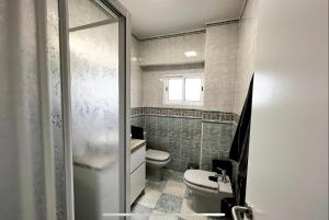 a bathroom with a toilet and a sink at Beach Retreat in Valencia +28 photos