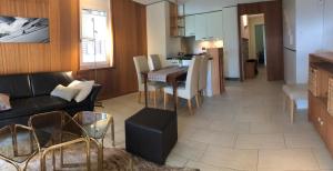 a living room with a couch and a dining room at Residence Edelweiss C311 in Bellwald