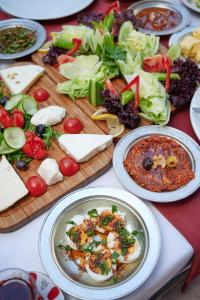 a table topped with plates of food and vegetables at Bayazhan Hotel ve Restaurant in Gaziantep