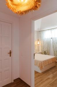 a bedroom with a bed and a chandelier at Diamond Roof in Los Cristianos