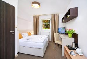 Posteľ alebo postele v izbe v ubytovaní Hotel Hradec