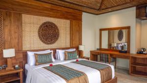 Ein Bett oder Betten in einem Zimmer der Unterkunft Sakti Garden Resort & Spa