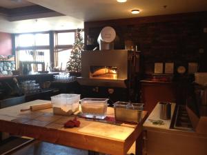 a kitchen with a table with an oven in it at Howe Sound Inn & Brewing Company in Squamish