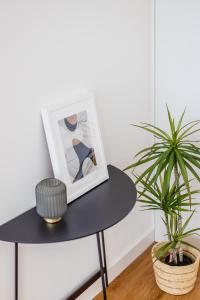 uma mesa com uma imagem e uma planta sobre ela em Pestana Apartments - Premium no Porto