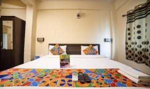 a bedroom with a bed with a colorful comforter at FabHotel East Field Homes in Pune