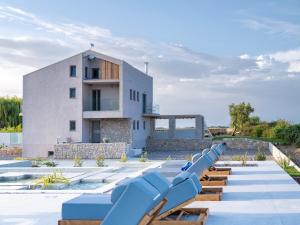 a row of blue slides in front of a building at Allure Wellness Retreat in Lefkada Town