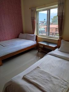 Una cama o camas en una habitación de Hotel Green Hill View