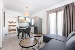 a living room with a couch and a table at Nefeli's Apartment in Kardamaina