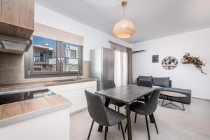 a kitchen and dining room with a table and chairs at Nefeli's Apartment in Kardamaina